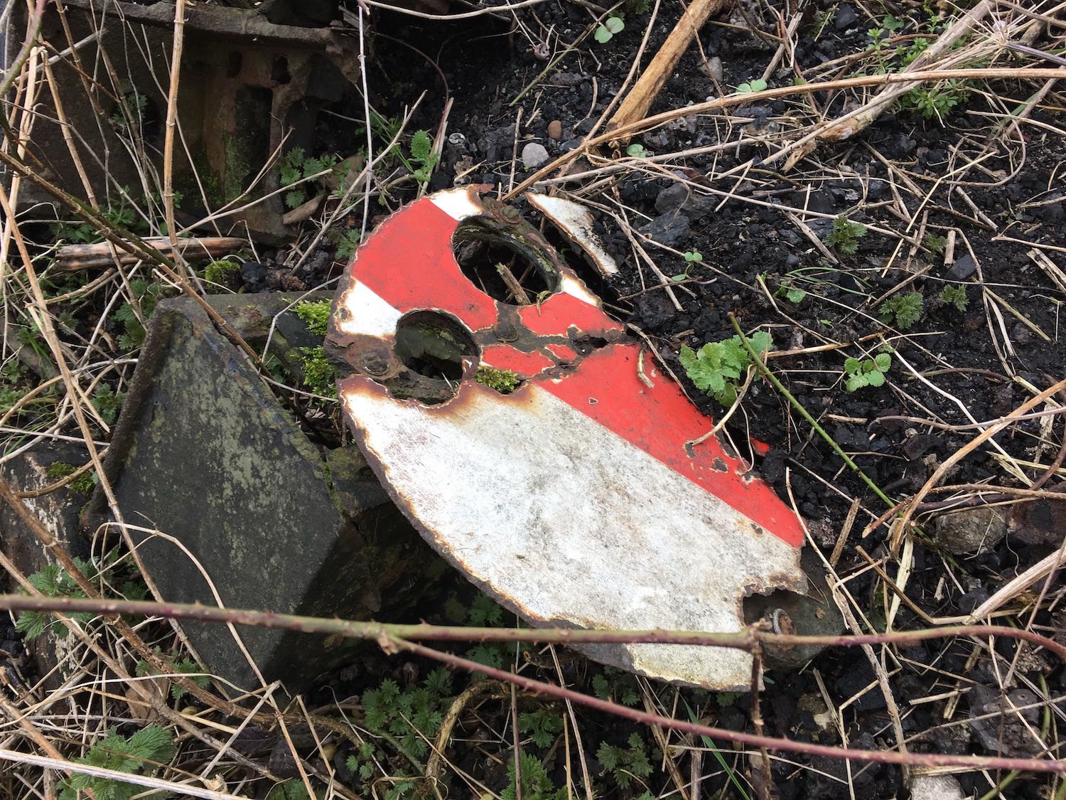 Fauld Sidings ground disc partially buried in the embankment